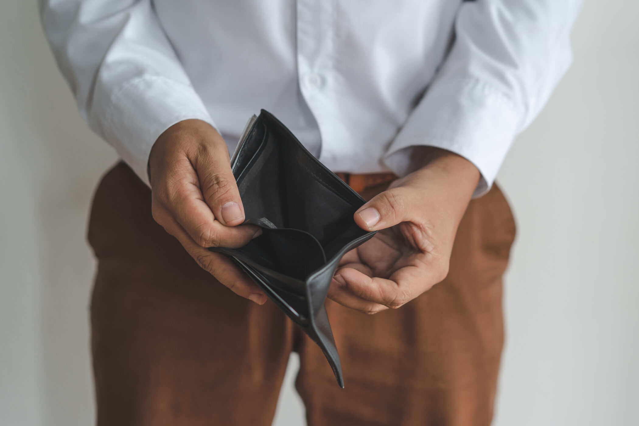 a man holding an empty wallet