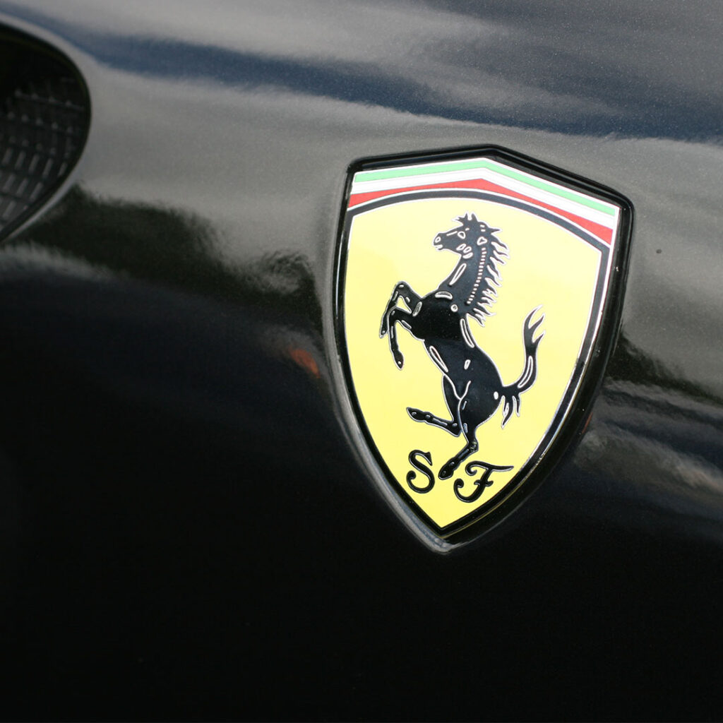A black Ferrari with a Yellow Ferrari badge