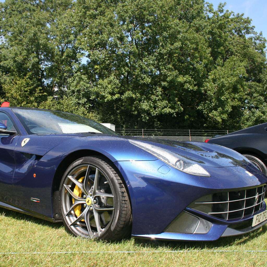 A blue Ferrari F12 at a Car Show
