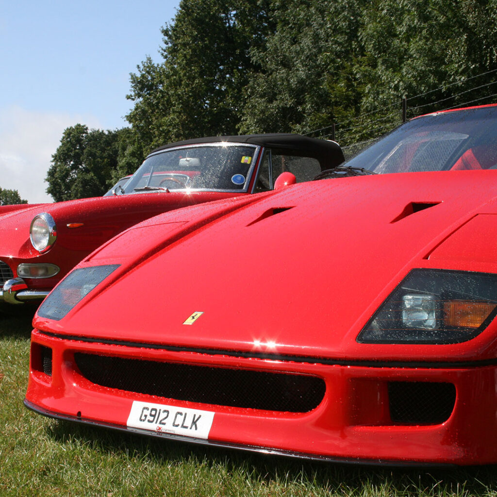 A red Ferrari F40 parked at a Car Show