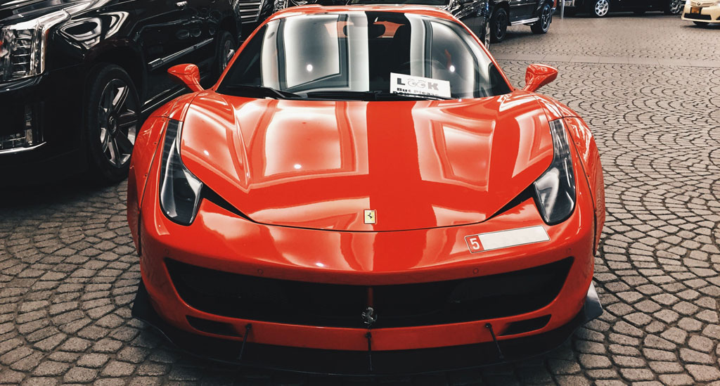 A Red Ferrari 458 Parked At A Hotel