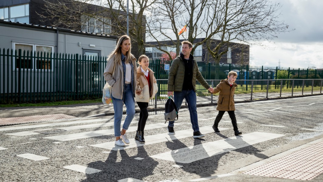 a family crossing the street with relevant life insurance cover