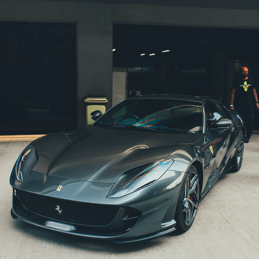 A Grey Ferrari F12 Outside a Garage