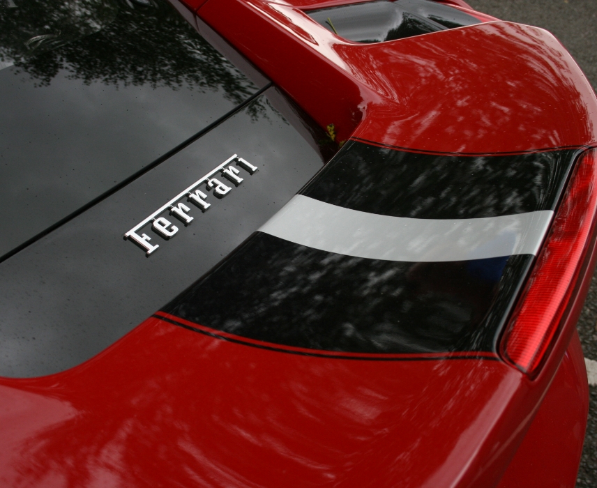 a red Ferrari and Ferrari logo