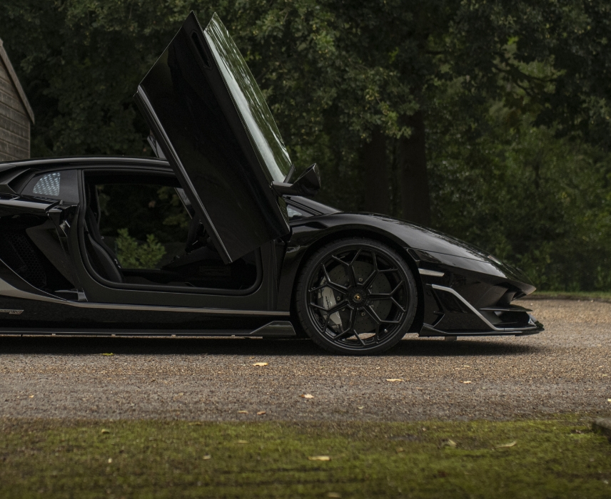 a black Lamborghini with the doors open
